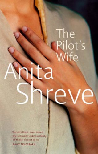 A hand rests on the chest of a person wearing a beige garment.