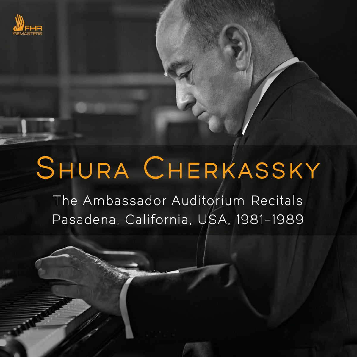 Black and white portrait of pianist Shura Cherkassky at a grand piano.