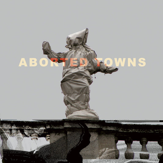 Hooded figure statue on a weathered stone balustrade, grey tones.