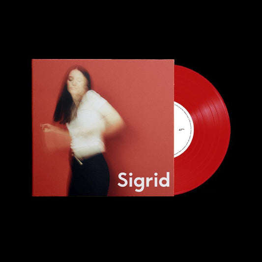 Sigrid album cover and red vinyl record against a black background.