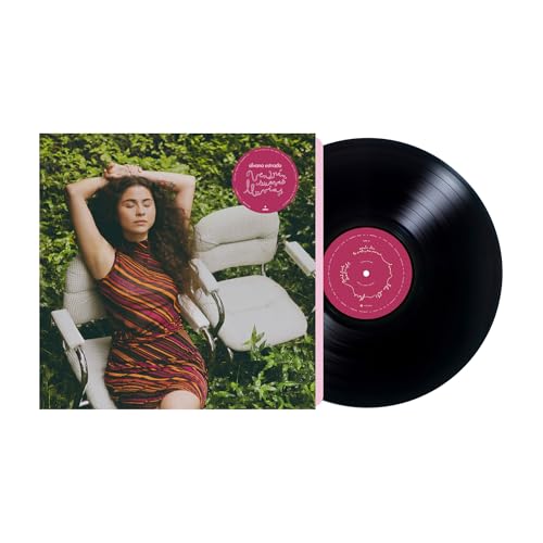 Vinyl record and album cover featuring a woman in a striped dress.