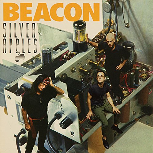 Album cover for Silver Apples' "Beacon" featuring musicians and electronic equipment.