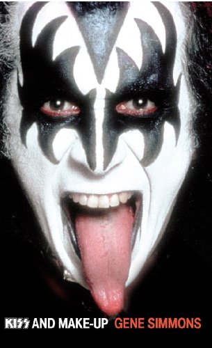 Close-up of Gene Simmons in black and white stage makeup with his tongue out.