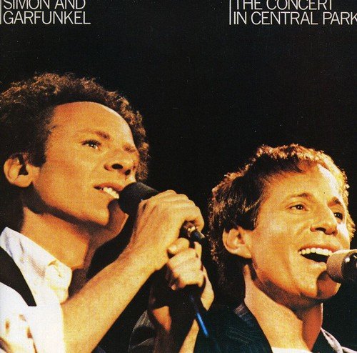 "Simon & Garfunkel album cover featuring the duo singing into microphones against a black background."