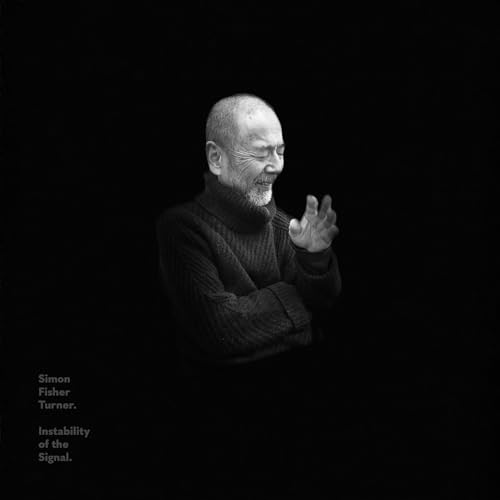 Black and white portrait of a man in a turtleneck against a black background.