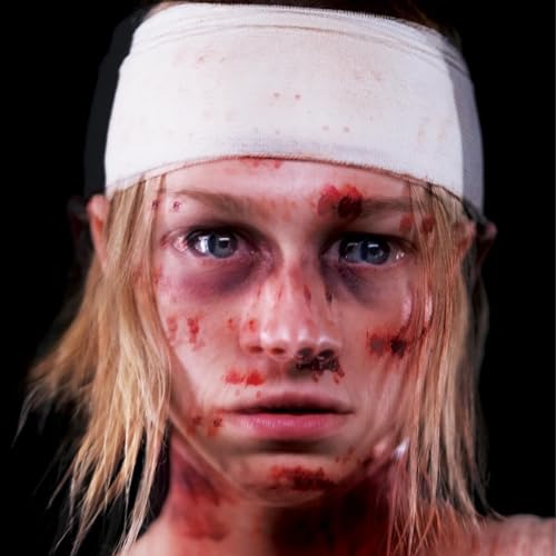 Woman with blonde hair, bandages, and visible facial injuries.