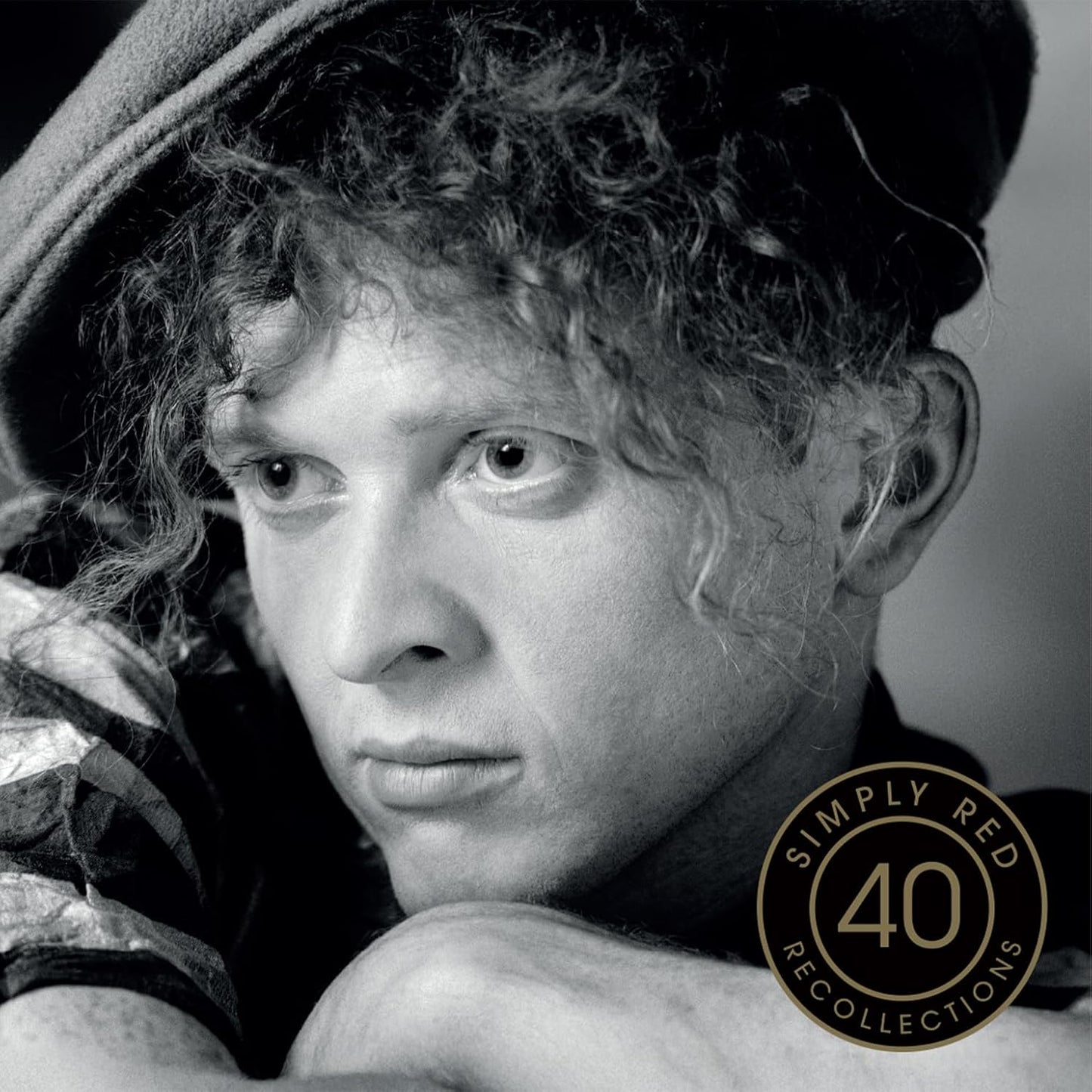 Black and white portrait of Mick Hucknall with "Simply Red 40 Recollections" logo.