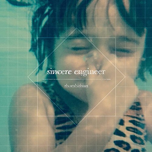 Vinyl record cover featuring a child’s face with a grid background.