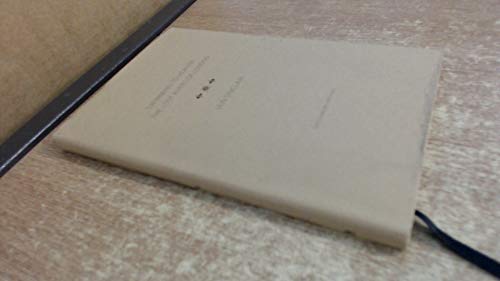 Closed beige book, “Swimming to Heaven,” rests on a wood-grain surface.