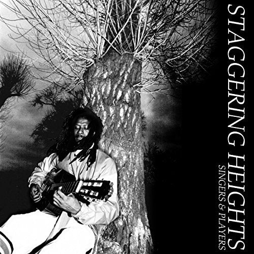 Black and white album cover featuring a musician with a guitar by a tree.
