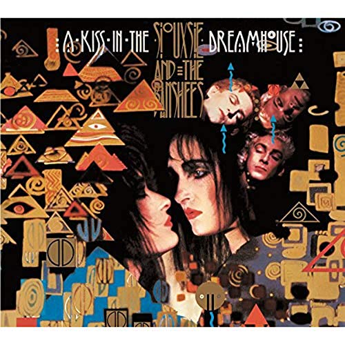 "Album cover featuring a woman's face surrounded by geometric shapes and multiple faces."