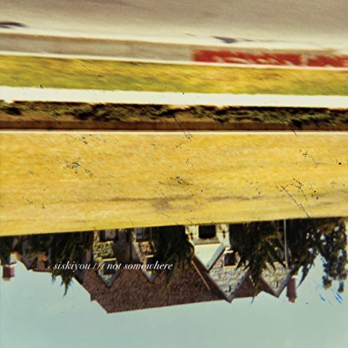 Upside-down image of a house and lawn with the text Siskiyou Not Somewhere.