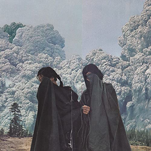 Two hooded figures stand before a cloudy, volcanic landscape.