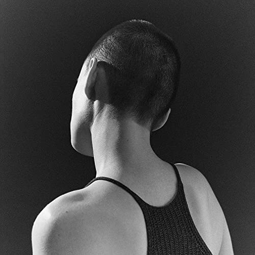 Black and white album cover showing the back of a shaved head.