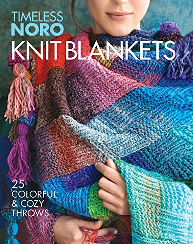 A person wearing a colorful, textured knit blanket with tassels on the cover of book.