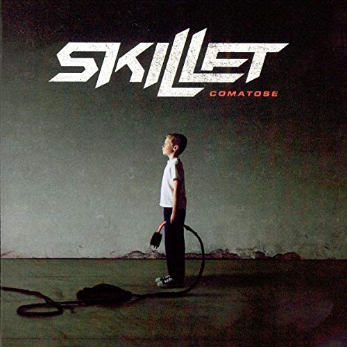 Skillet's "Comatose" CD cover: boy with IV drip against a gray sky.