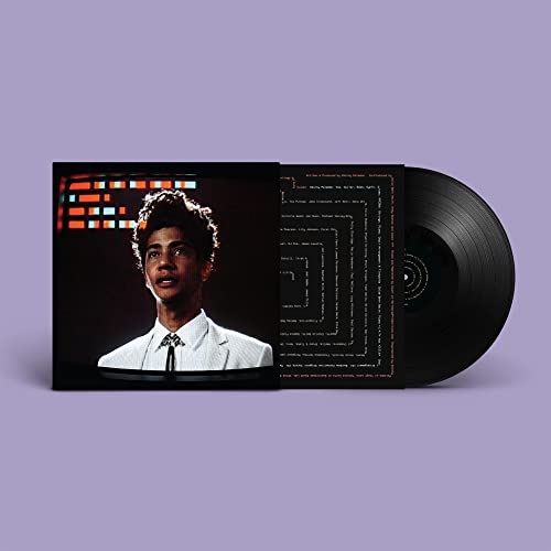 Vinyl record with album cover featuring a man in a suit.