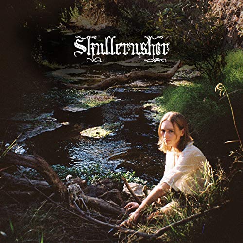 Album cover with a woman seated by a stream and skeletal remains.