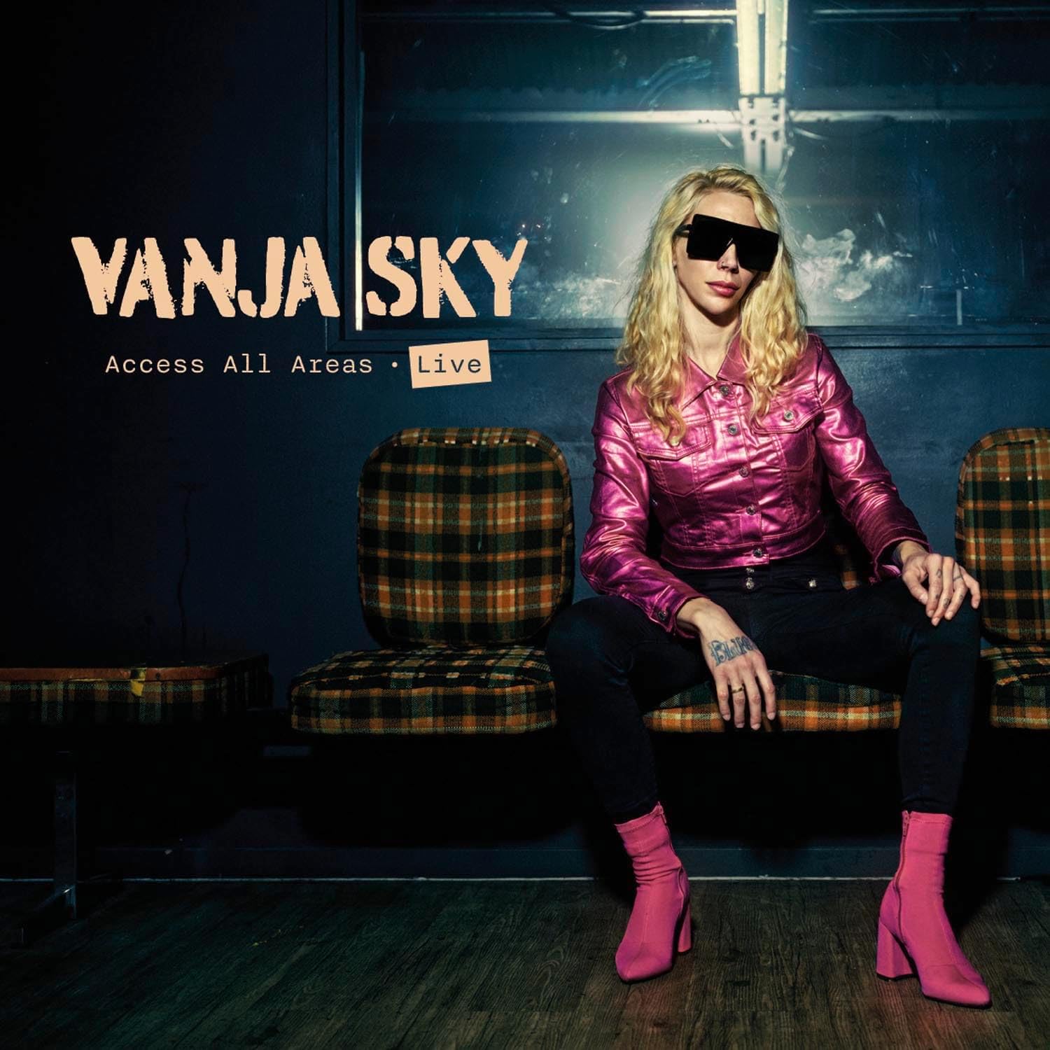 Vanja Sky album cover: woman with sunglasses sitting on chairs.