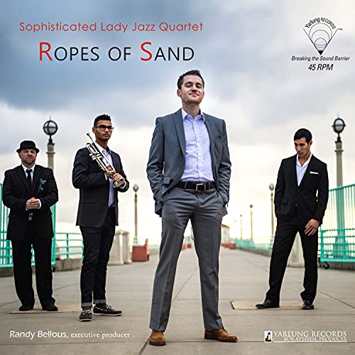 Jazz quartet in suits on a pier under a cloudy sky.