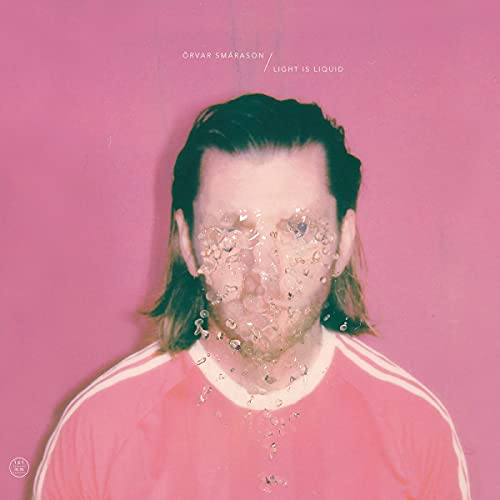 Album cover: man’s face with water droplets, pink background.