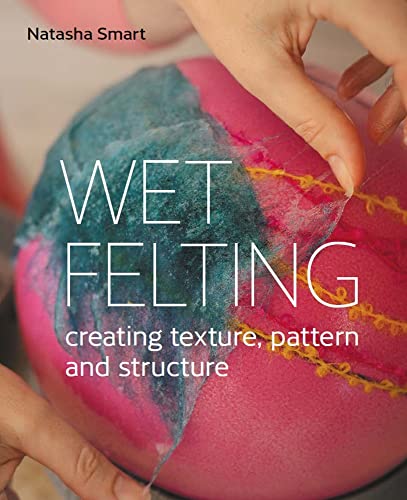 Hands shaping a colorful felted ball with pink, teal, and yellow hues.