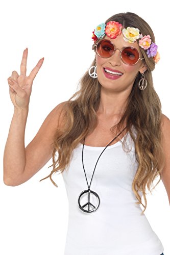 A woman wearing a white tank top, floral headband, peace sign accessories, and making a peace sign.