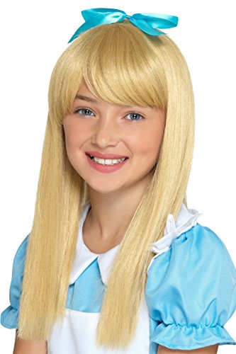 Young girl wearing a blonde wig with a blue bow, smiling directly at the camera.