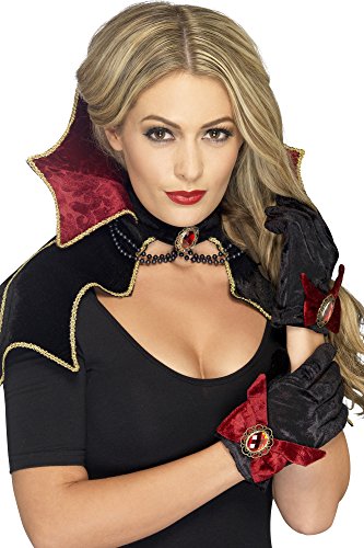 Woman wearing a black and red vampire princess costume with gold trim.