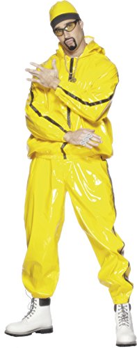 Man wearing a yellow tracksuit, beanie, sunglasses, gold chain, and white boots.