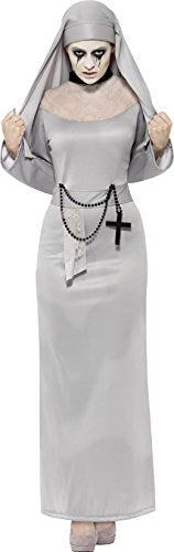 Woman in grey nun costume with pale makeup, rosary, and cross, holding veil over face.