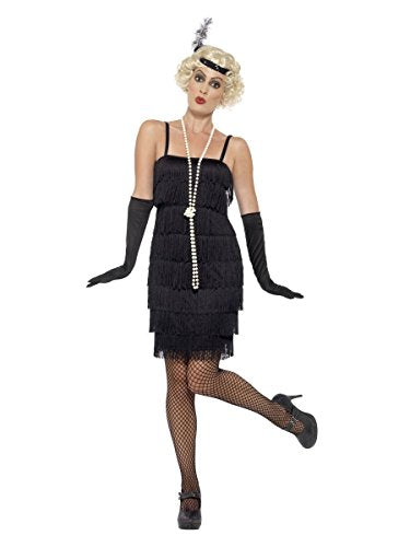 Woman modeling a black 1920s flapper costume with fringe and pearls.