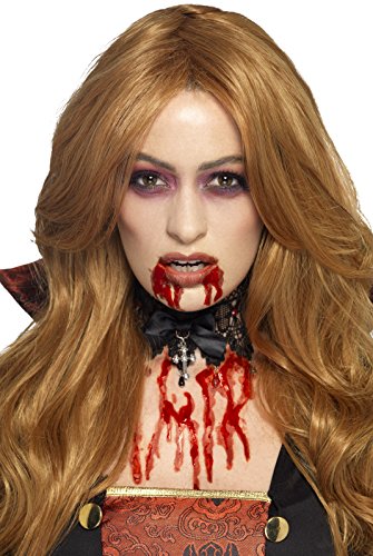 Woman with long auburn hair and realistic fake blood makeup.