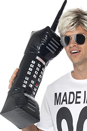 Man holding large inflatable black retro mobile phone with keypad and antenna.