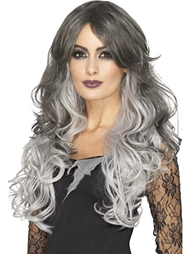 A woman models a long, curly grey and black wig, wearing a black dress.
