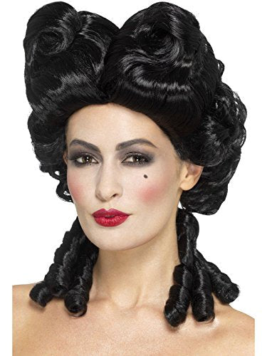 Woman wearing a large, curly black wig with red lipstick against a white background.