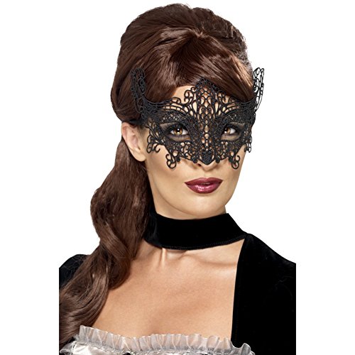 A woman wearing a black filigree lace eye mask with intricate swirl patterns.