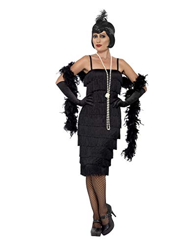 Woman modeling a black, fringed 1920s flapper dress with headband and gloves.