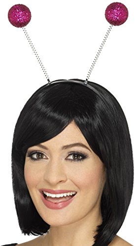 Woman wearing a black wig and headband with pink glitter balls on chains.