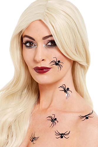 A woman with blonde hair wearing several black 3D spider stickers on her face.