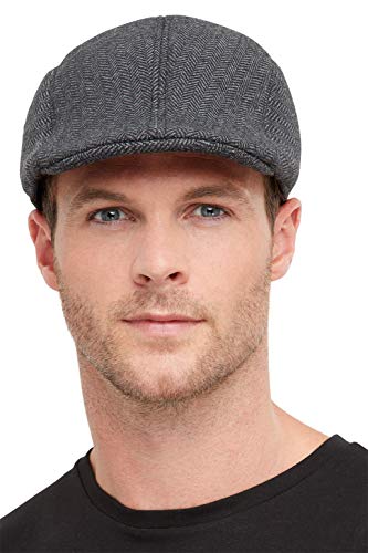 Grey herringbone flat cap worn by a man with short brown hair.