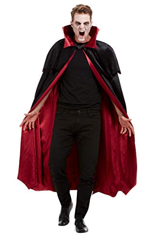 Man in vampire costume wearing a black cape with a red satin lining.