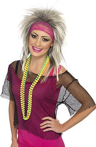 A woman wearing a black string vest and 80s-themed accessories in packaging.