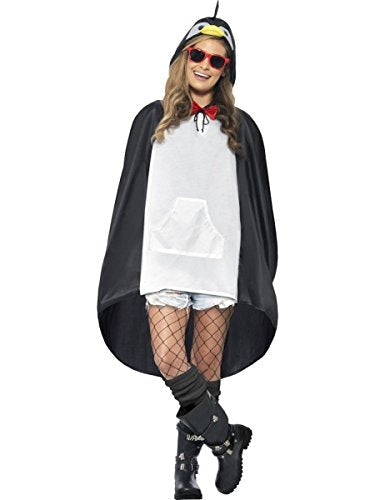 A woman wearing a black and white penguin poncho with a hood and red bowtie.
