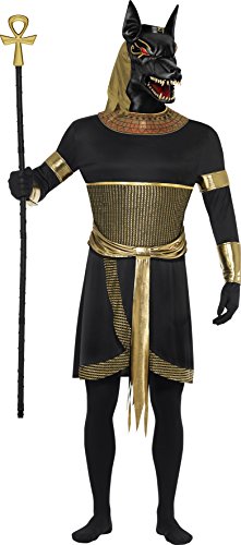 A person wearing an Anubis jackal mask, black tunic, gold collar, and holding an ankh.