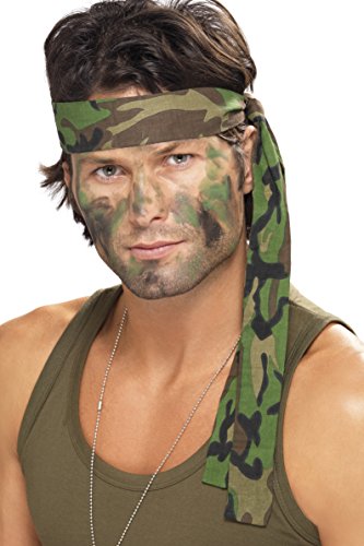 A man wearing a camouflage headband and camouflage face paint against a white background.