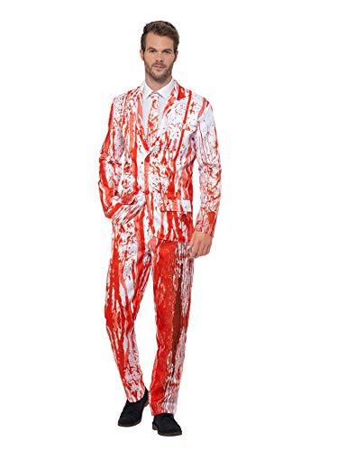 Man wearing a white suit covered in realistic-looking red blood splatters.