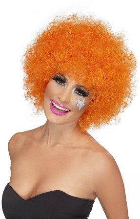 Bright orange, curly clown wig worn by a woman with star makeup.