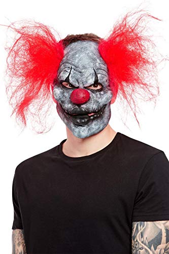 Gray and black clown mask with red, wild hair worn by a person.