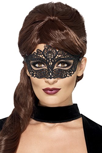 "Woman wearing a black lace eye mask and black velvet choker against a white background."